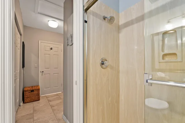 a bedroom with a bed and a large window with the outer view