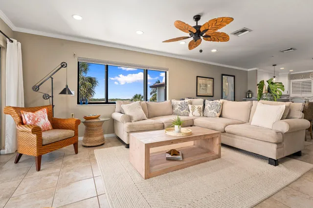 a living room with furniture and ceiling fan