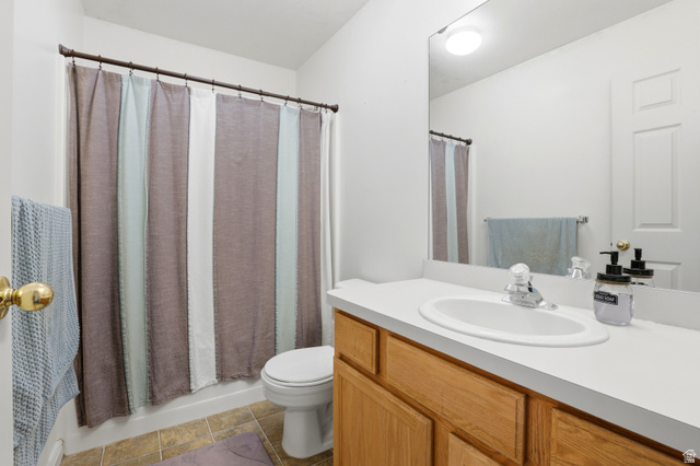 8083 North Ridge Loop East, Unit I 9 Eagle Mountain, UT 84005 - Photo 13 of 17 Bathroom with vanity, light tile patterned floors, and shower / bathtub combination with curtain