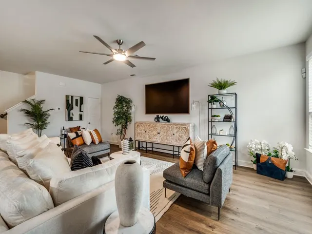 a living room with furniture and a flat screen tv