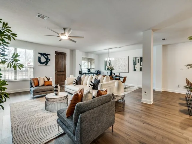 a living room with lots of furniture and a chandelier