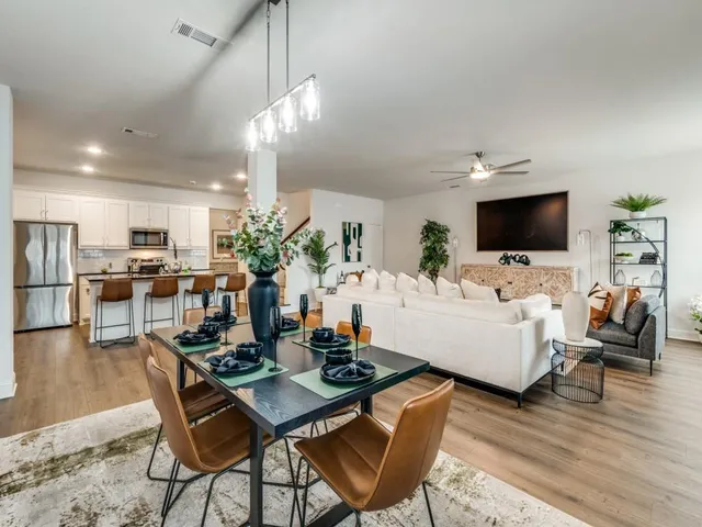a living room with lots of furniture and kitchen view