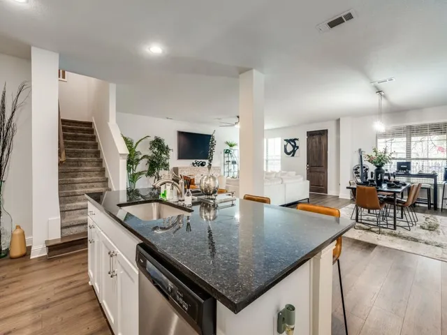 a bedroom with a bed a table and painting on the wall