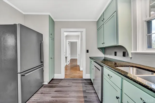 a kitchen with a refrigerator sink and cabinets