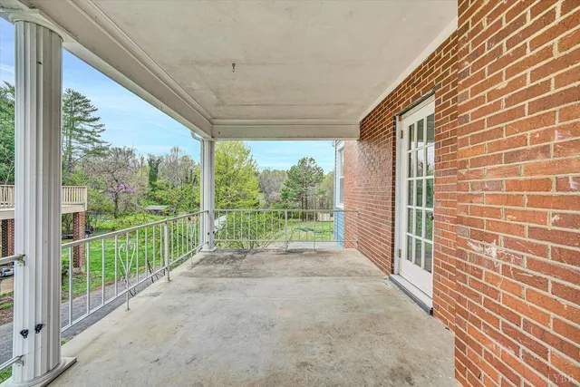 a view of a porch with a floor to ceiling window
