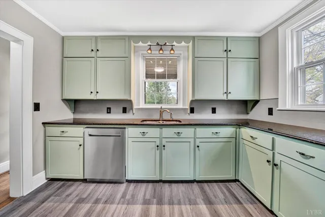 a kitchen with stainless steel appliances granite countertop cabinets a window a sink and a stove