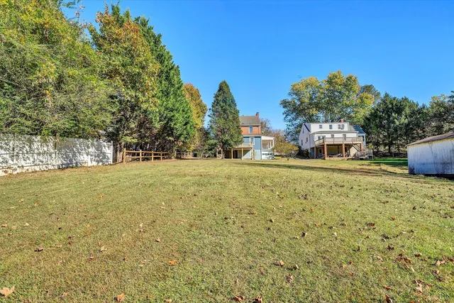 a house view with swimming pool in front of it