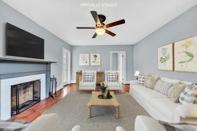 a view of empty room with wooden floor and fireplace