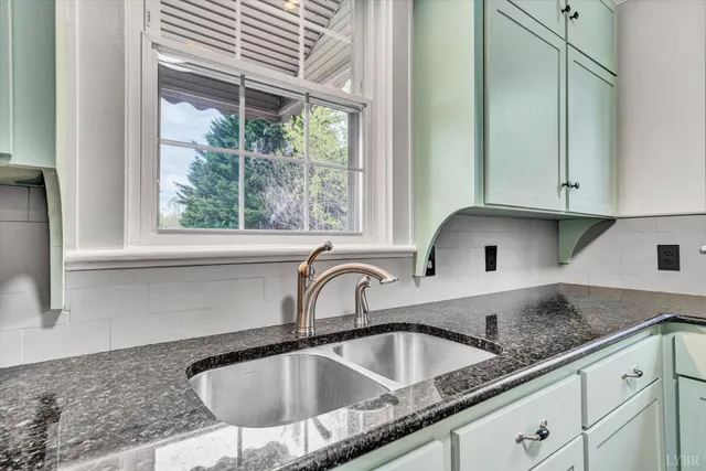 a kitchen with granite countertop a sink and a window