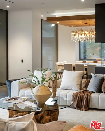 a dining room with furniture a chandelier and wooden floor