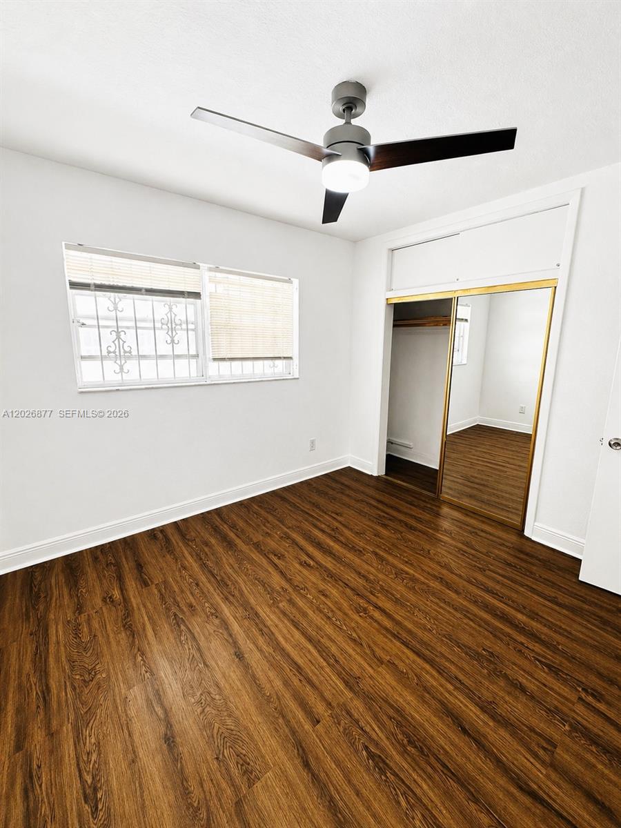 2727 Southwest 24th Street Miami, FL 33145 - Photo 6 of 18 a view of empty room with wooden floor and fan
