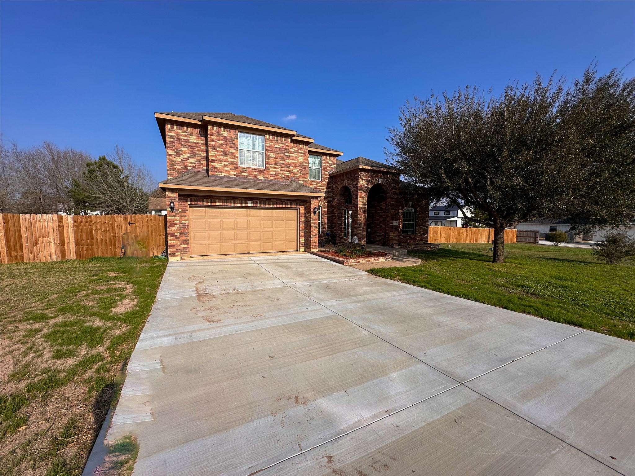 237 Cardinal Drive Paige, TX 78659 - Photo 2 of 37 Traditional home featuring brick siding, driveway, and a garage