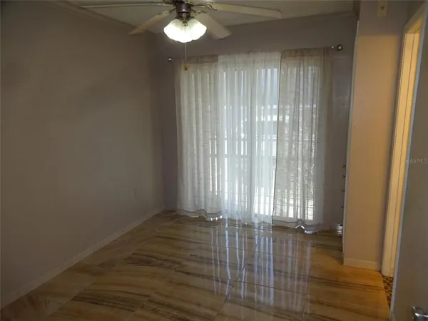 a view of wooden floor and window in an empty room