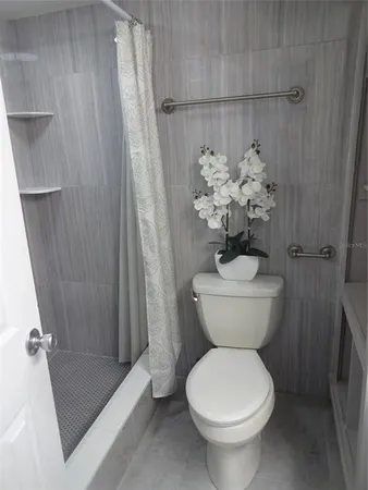 a bathroom with a sink a toilet and a shower