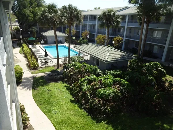 a view of backyard with plants and outdoor seating