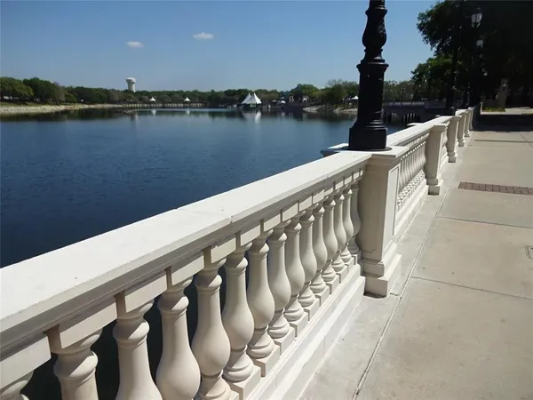 a balcony with wooden floor and lake view