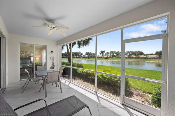 a living room with couch and a floor to ceiling window