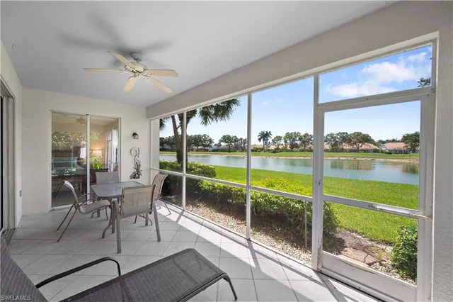 a living room with couch and a floor to ceiling window