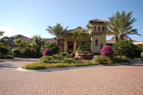 a front view of a house with a yard and potted plants