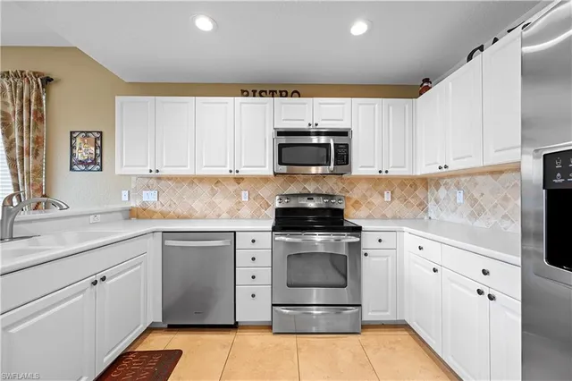 a kitchen with a stove a sink and a microwave