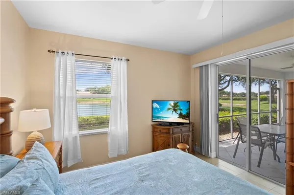 a bedroom with a bed and glass door