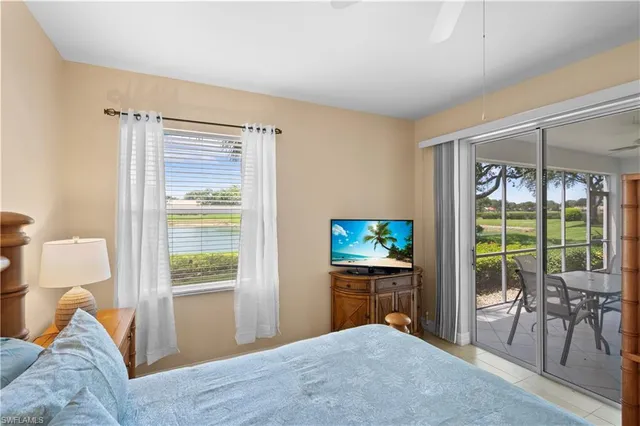 a bedroom with a bed and glass door