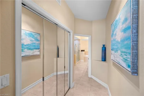 a bathroom with a glass shower door and a window