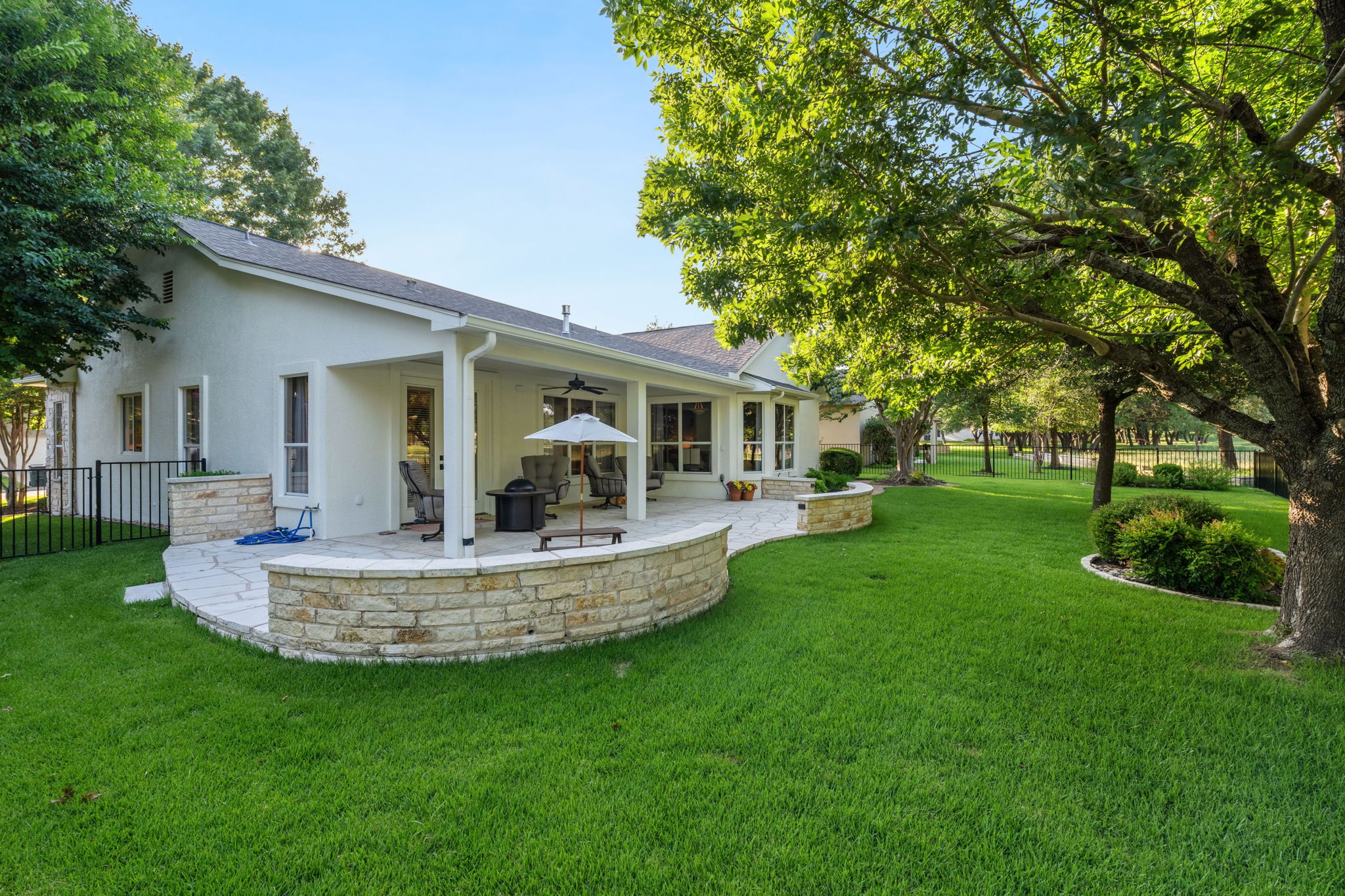 118 Cold Springs Drive Georgetown, TX 78633 - Photo 39 of 40 An inviting backyard oasis features a spacious covered patio and mature shade trees, perfect for outdoor gatherings.