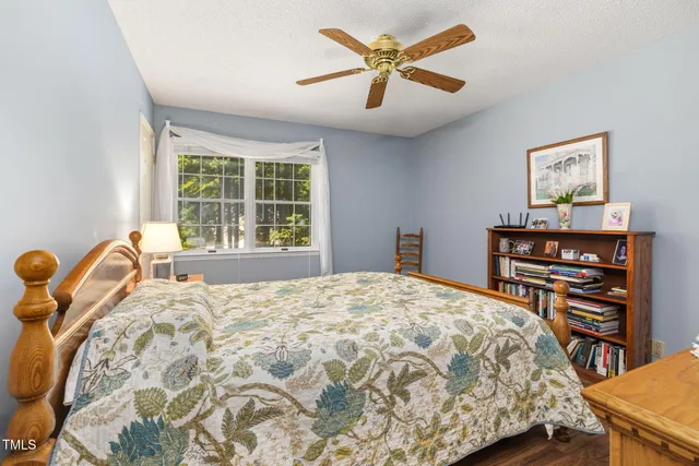 a bed sitting in a bedroom next to a window