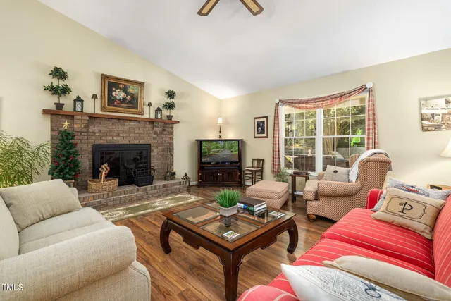 a living room with furniture a fireplace and a flat screen tv