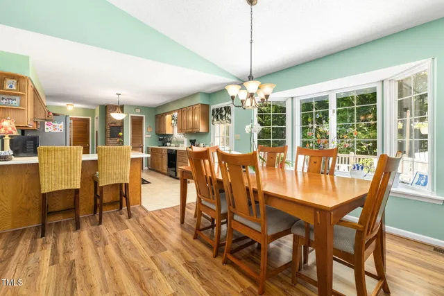 a view of a dining room with furniture wooden floor and chandelier