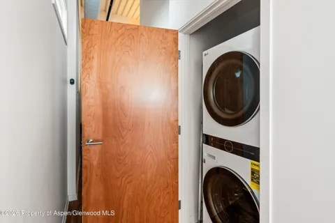 a view of a hallway with washer and dryer