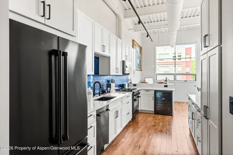 a kitchen with a sink a refrigerator a stove a microwave and cabinets