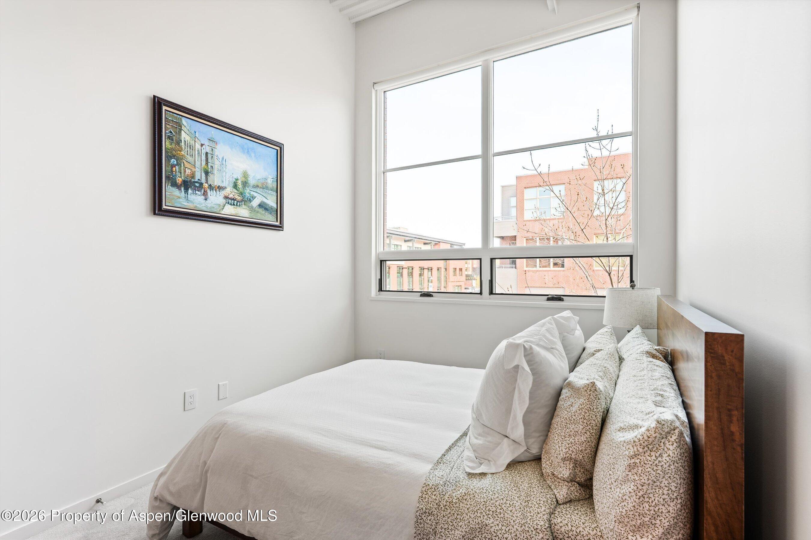 361 Robinson Street, Unit 208 Basalt, CO 81621 - Photo 8 of 15 a bed sitting in a bedroom next to a window