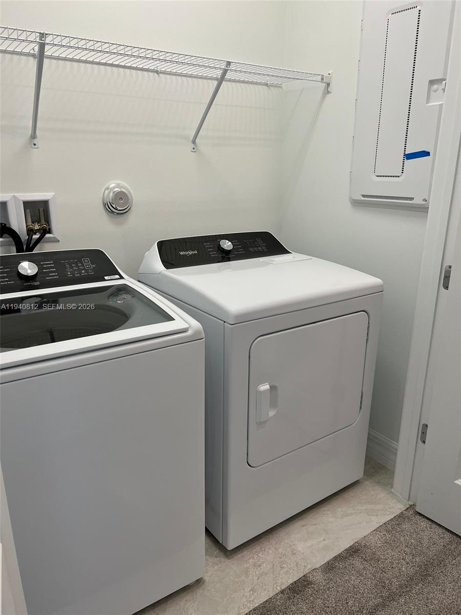 6121 Rancho Lane Greenacres, FL 33415 - Photo 14 of 17 a utility room with dryer and washer