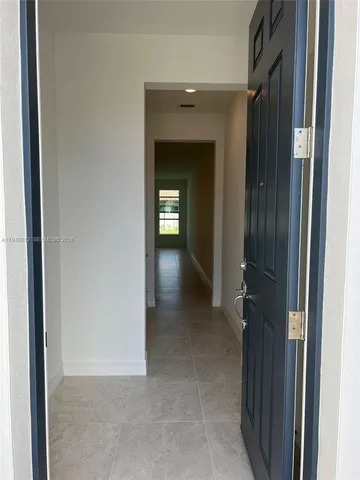 a view of a hallway with wooden shelves