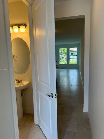 a view of a bathroom from a hallway