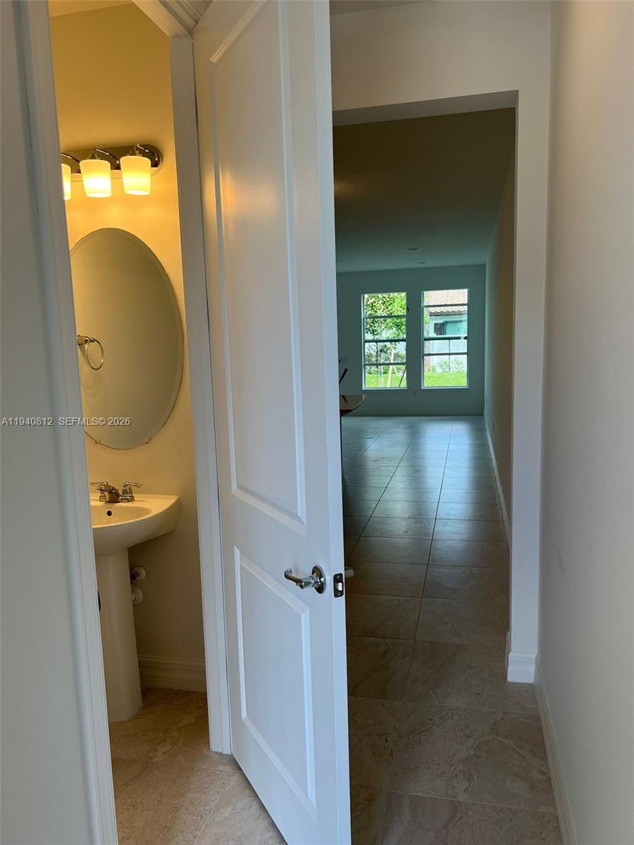 6121 Rancho Lane Greenacres, FL 33415 - Photo 9 of 17 a view of a bathroom from a hallway