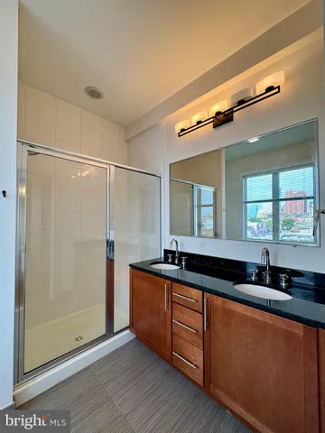 a kitchen with granite countertop a sink and a refrigerator