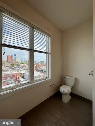 a bathroom with a toilet sink and window