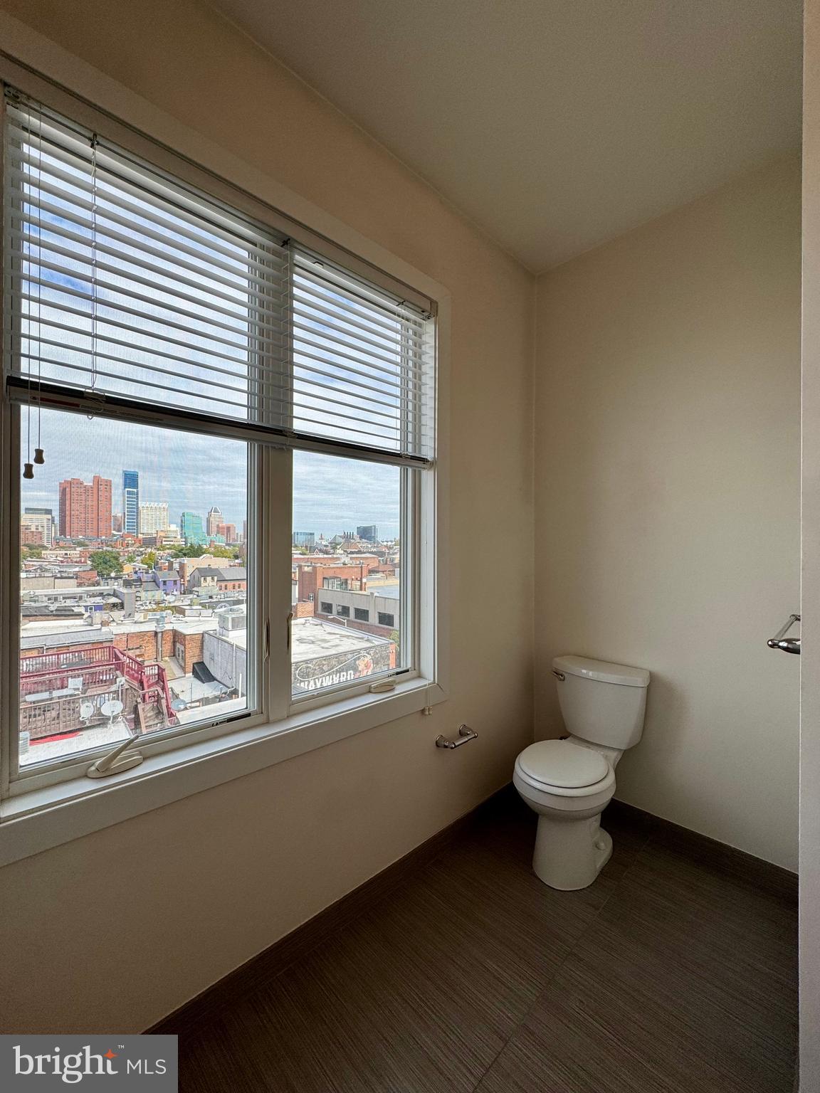 1201 South Charles Street, Unit 5A Baltimore, MD 21230 - Photo 14 of 15 a bathroom with a toilet sink and window
