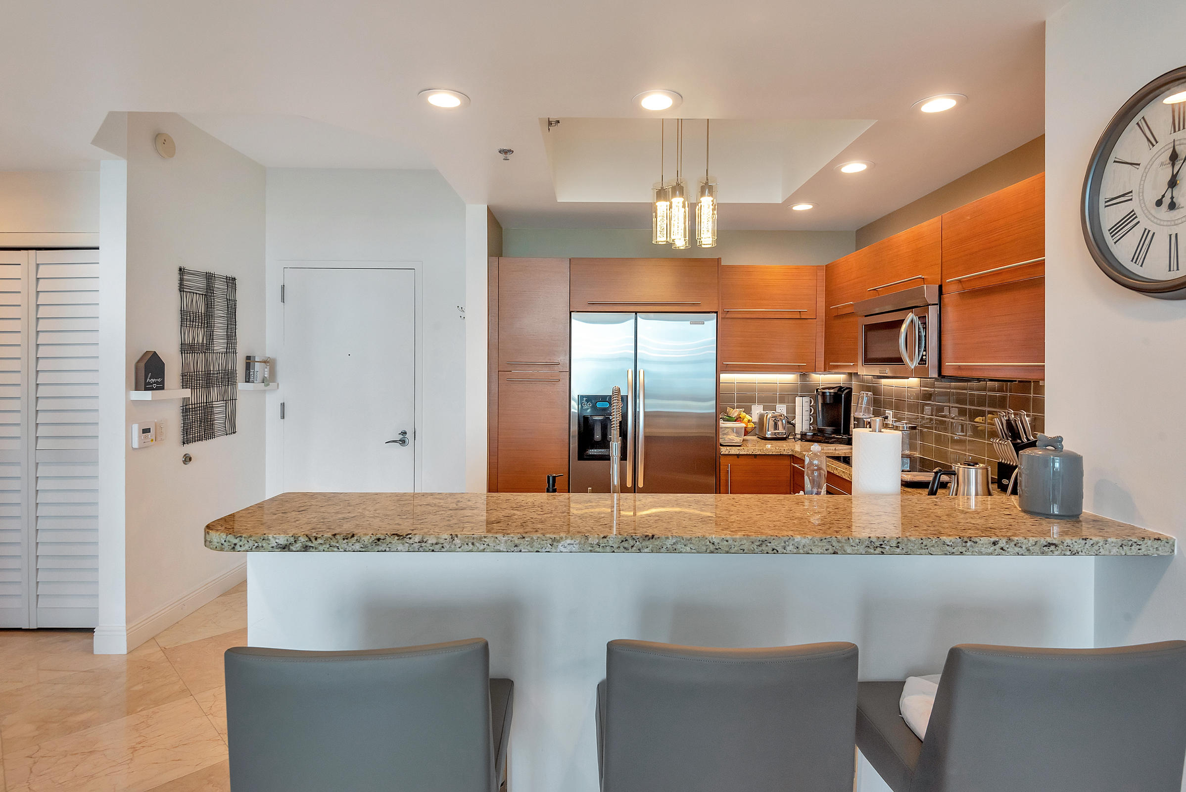 2641 North Flamingo Road, Unit 2503N Sunrise, FL 33323 - Photo 13 of 47 a kitchen with stainless steel appliances granite countertop a sink and a refrigerator