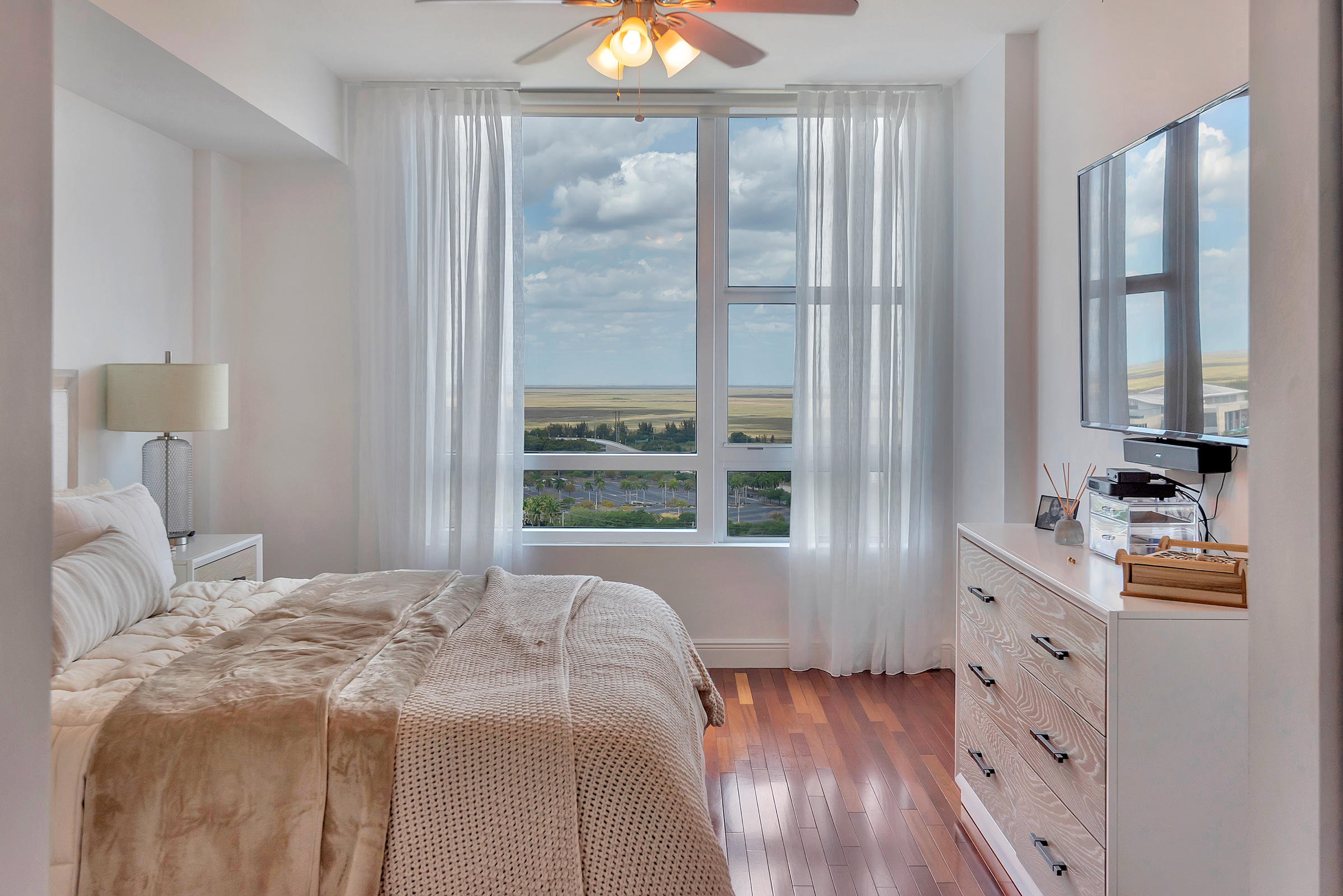 2641 North Flamingo Road, Unit 2503N Sunrise, FL 33323 - Photo 14 of 47 a bedroom with a bed and a large window