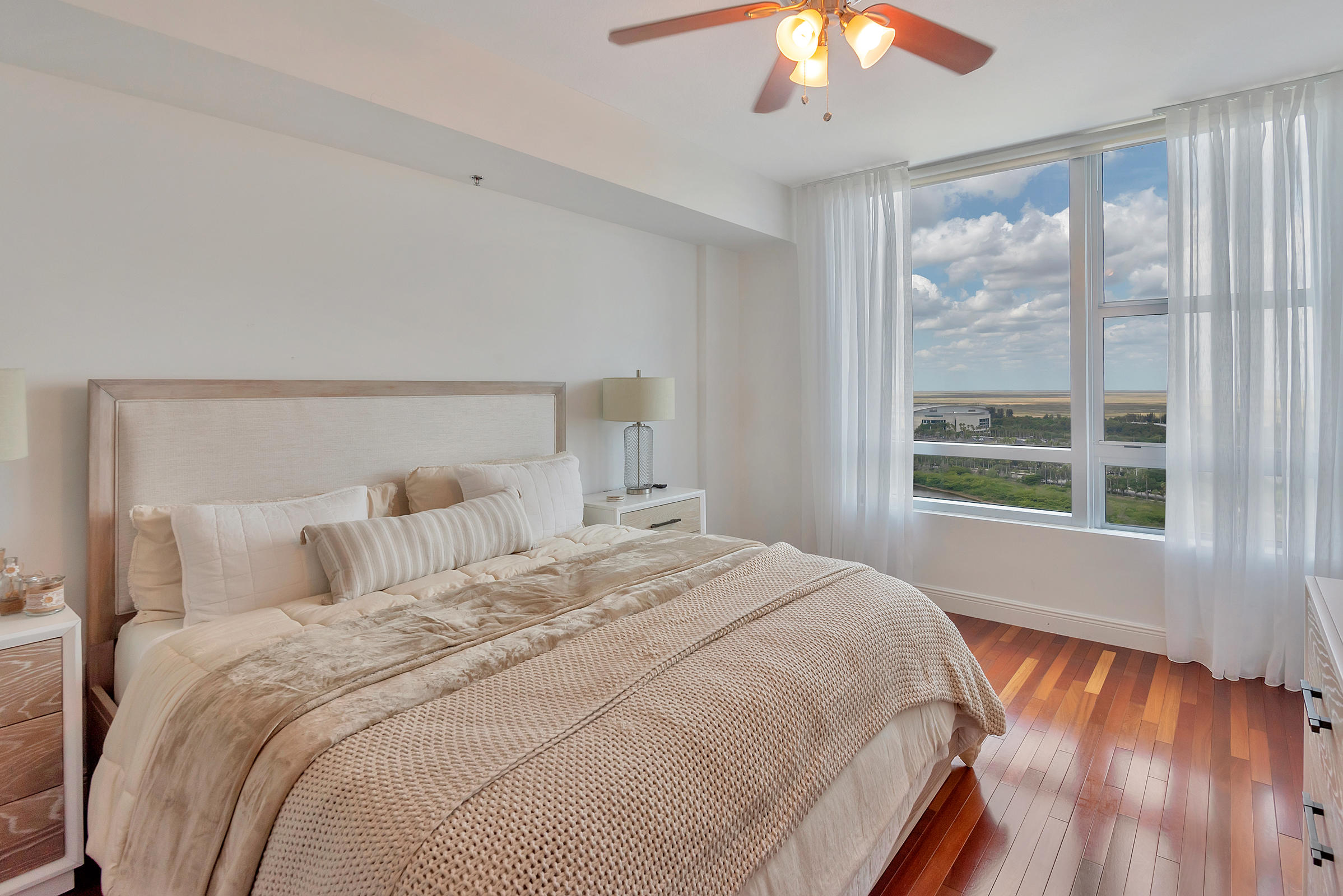 2641 North Flamingo Road, Unit 2503N Sunrise, FL 33323 - Photo 15 of 47 a bedroom with a large bed and a chandelier