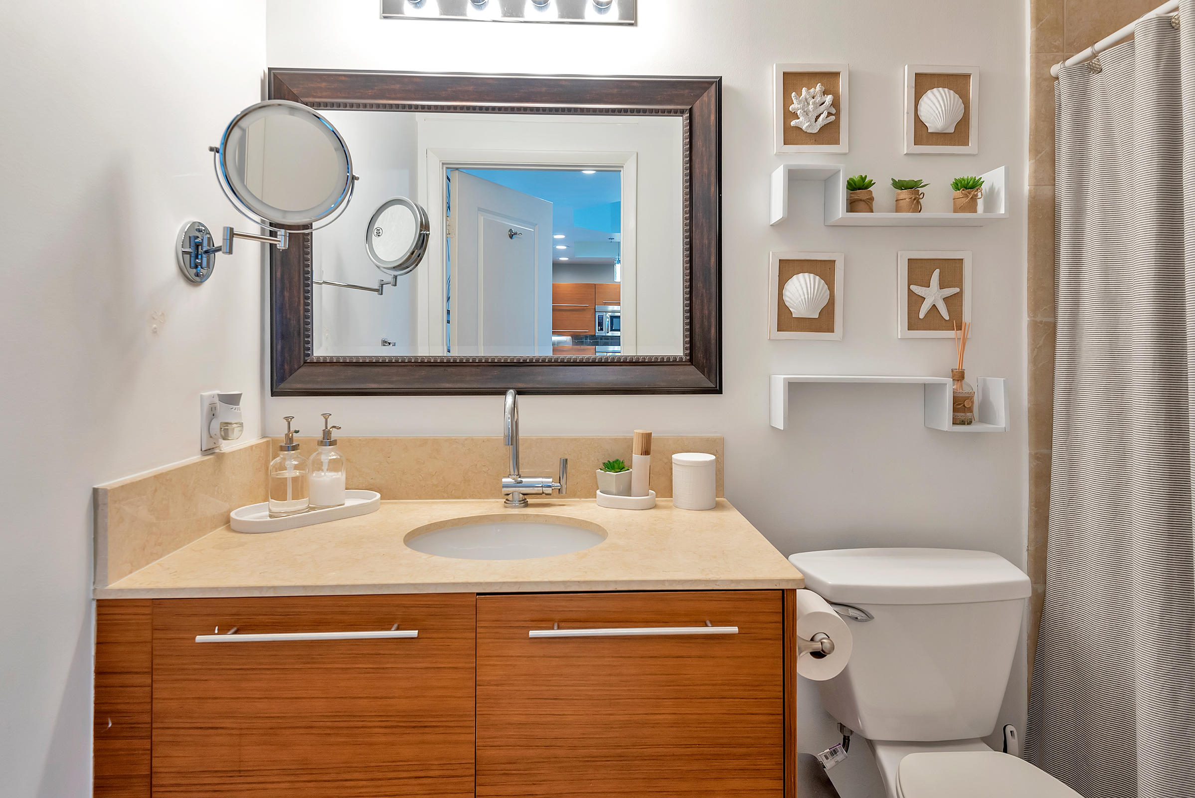2641 North Flamingo Road, Unit 2503N Sunrise, FL 33323 - Photo 24 of 47 a bathroom with a toilet a sink and a mirror