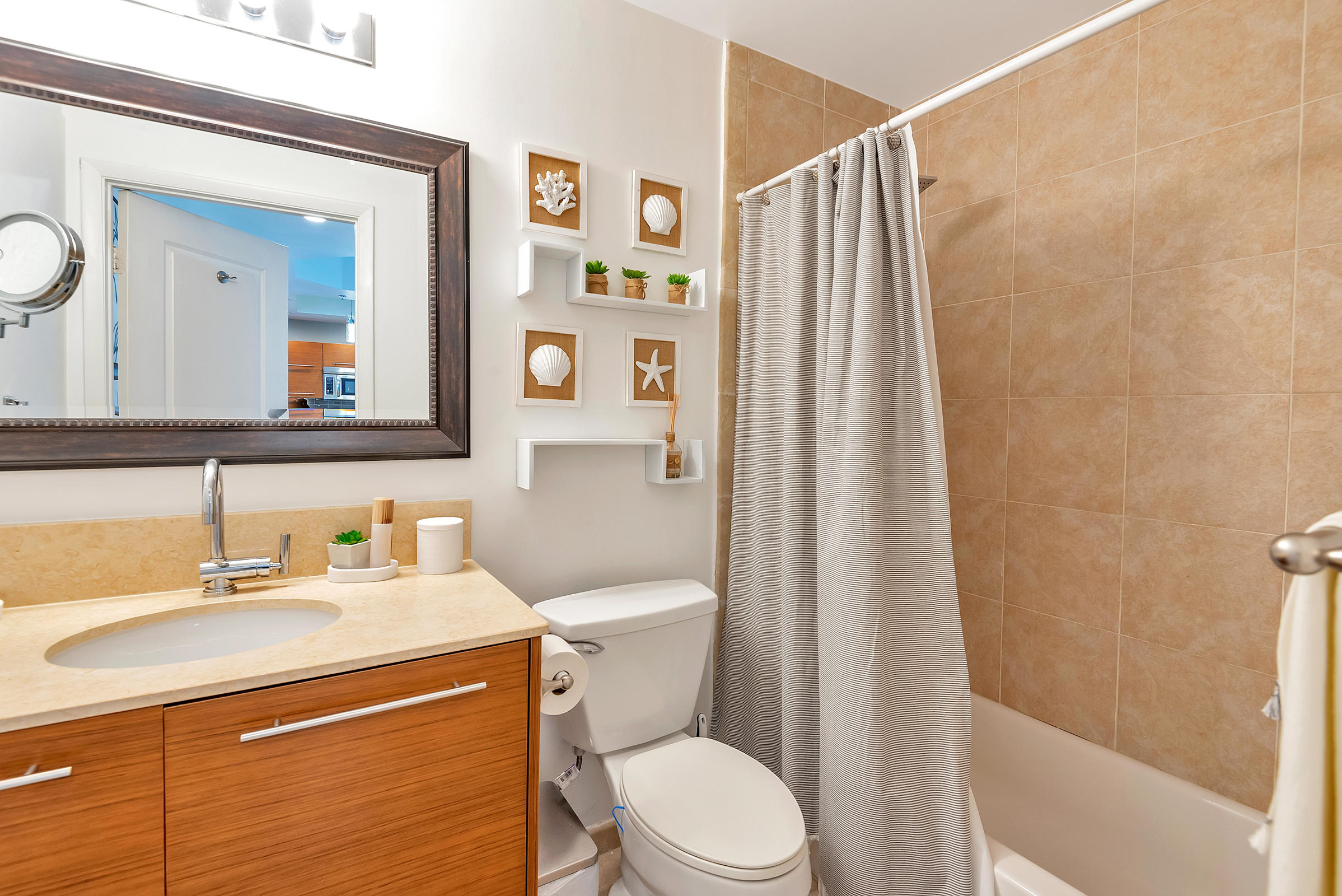 2641 North Flamingo Road, Unit 2503N Sunrise, FL 33323 - Photo 25 of 47 a bathroom with a sink a toilet and shower curtain