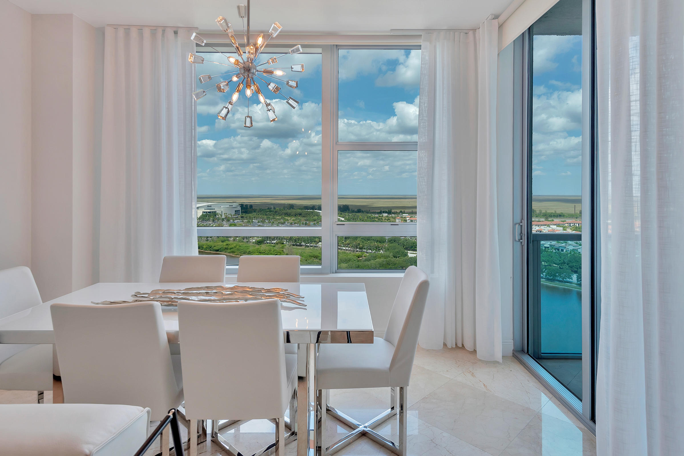 2641 North Flamingo Road, Unit 2503N Sunrise, FL 33323 - Photo 3 of 47 a view of a dining room with furniture large windows and wooden floor