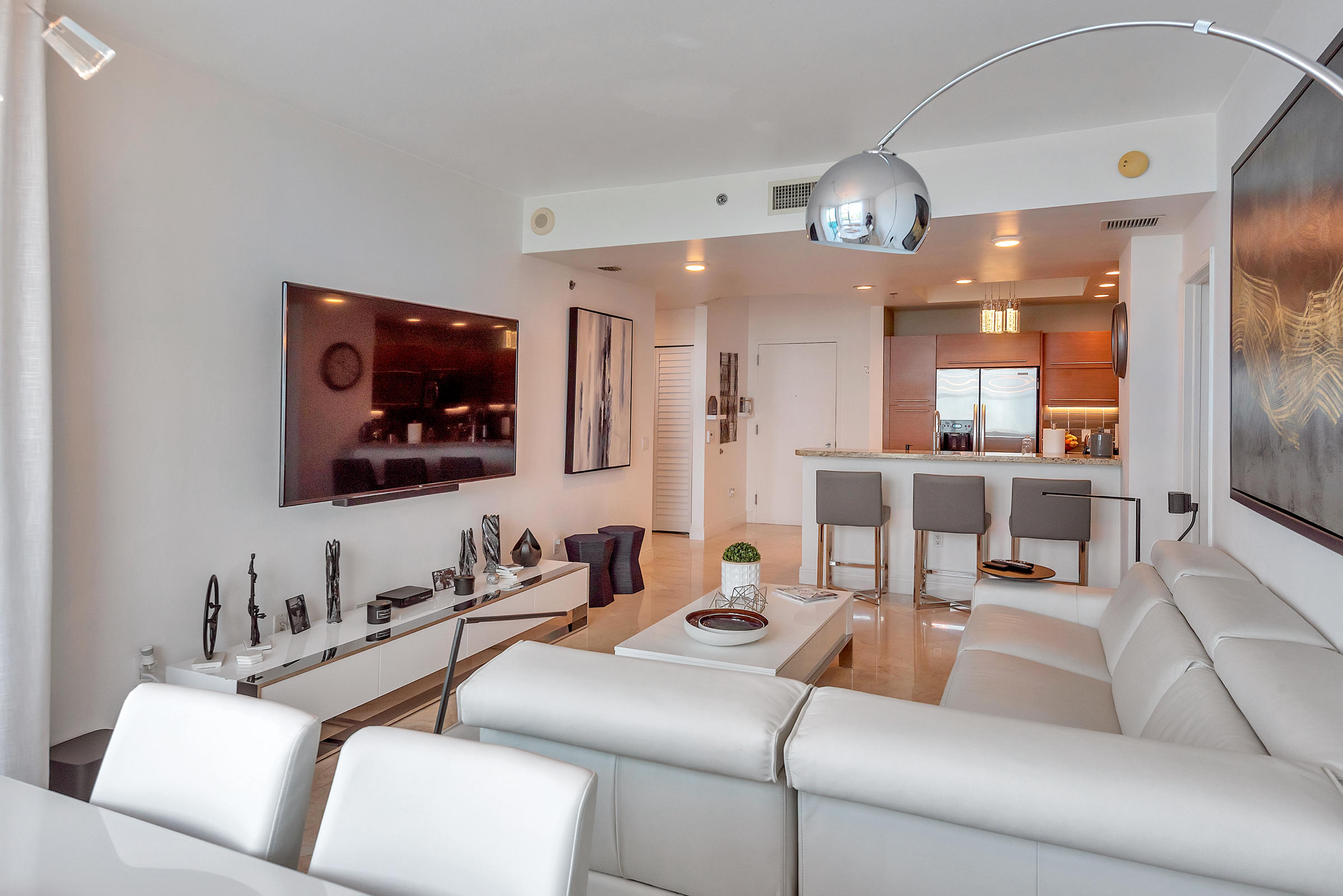 2641 North Flamingo Road, Unit 2503N Sunrise, FL 33323 - Photo 5 of 47 a living room with furniture and a flat screen tv