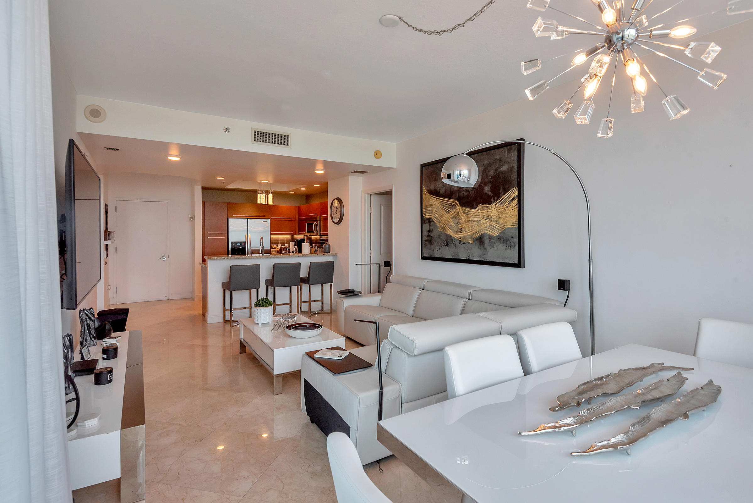 2641 North Flamingo Road, Unit 2503N Sunrise, FL 33323 - Photo 7 of 47 a living room with furniture and a chandelier