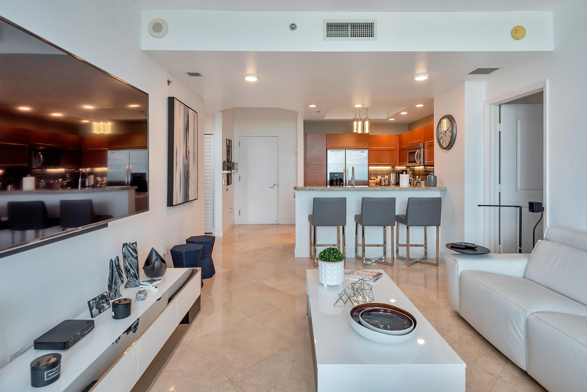 2641 North Flamingo Road, Unit 2503N Sunrise, FL 33323 - Photo 8 of 47 a living room with kitchen island furniture and a view of kitchen
